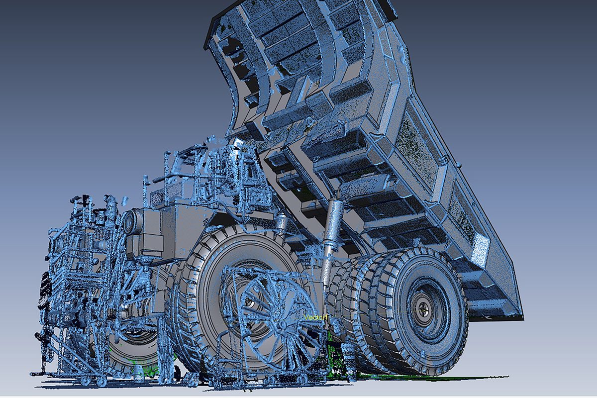 Mining haul truck in Geomagic Design X, with blue 3D scan data around the solid CAD model being rebuilt from it